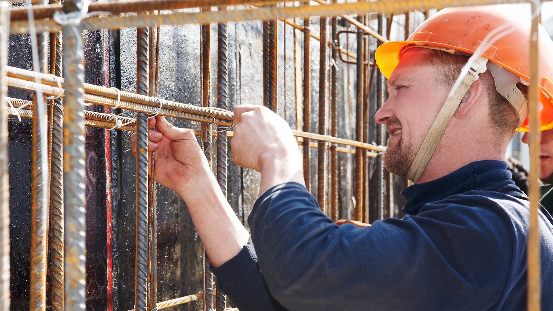 Construction worker tying rebar
