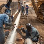 Laborers working on pipeline