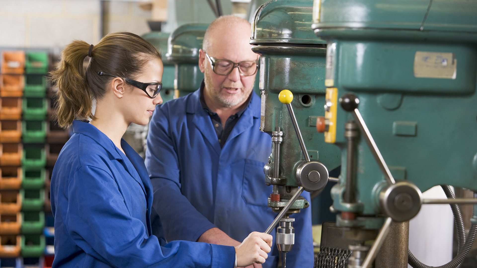 Two machinists working on machine