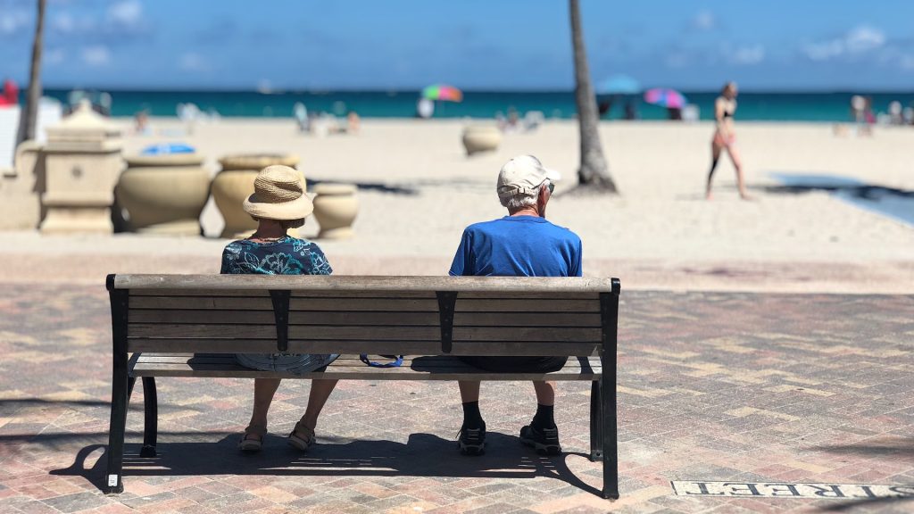Adults on a beach bench