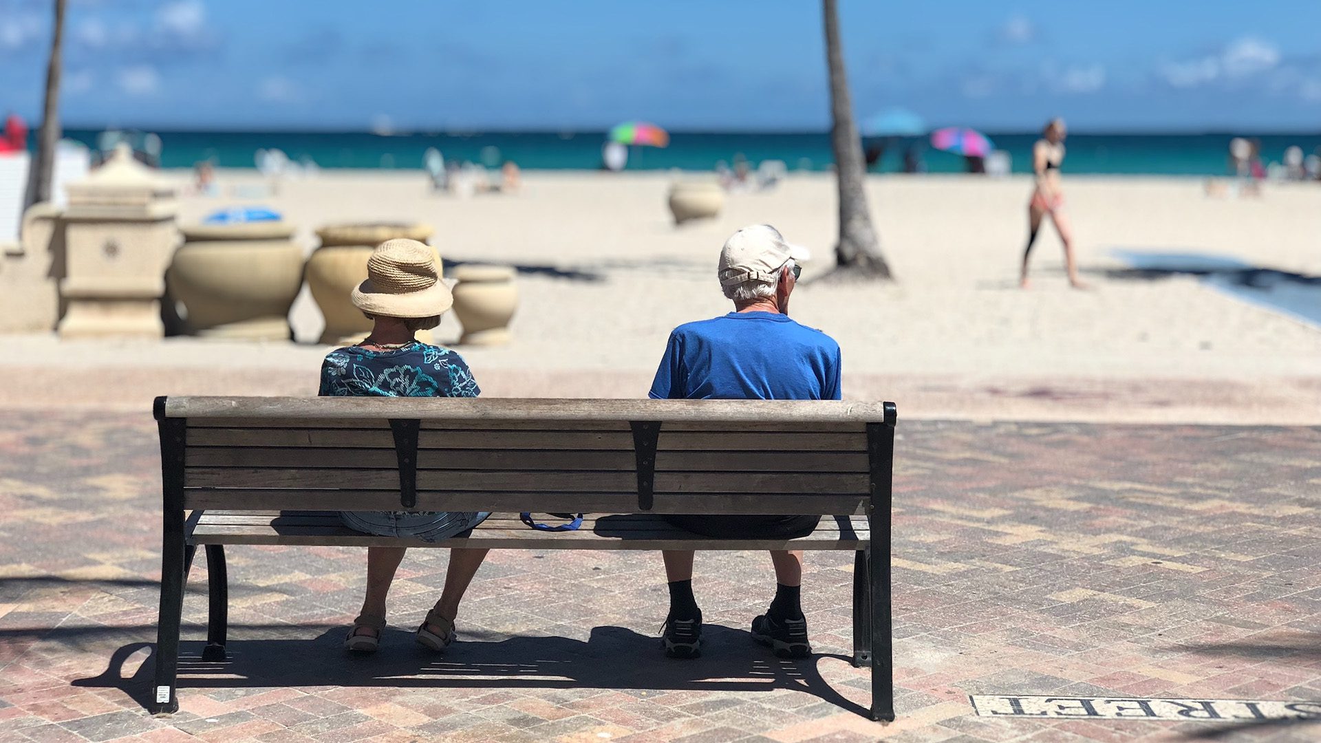 Adults on a beach bench