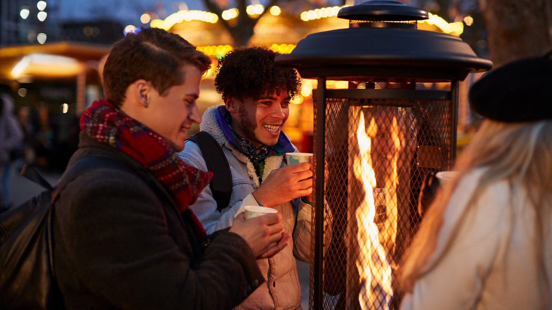 Friends Gathered Around Outdoor Heater