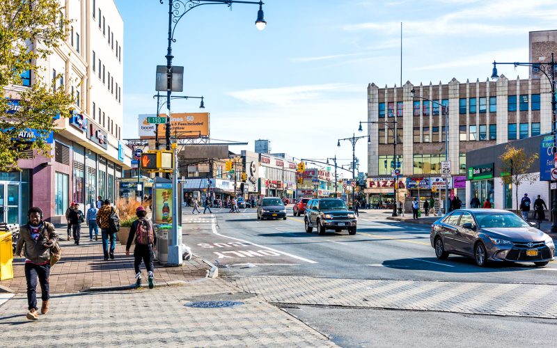 People crossing street in Fordham Heights center, New York City