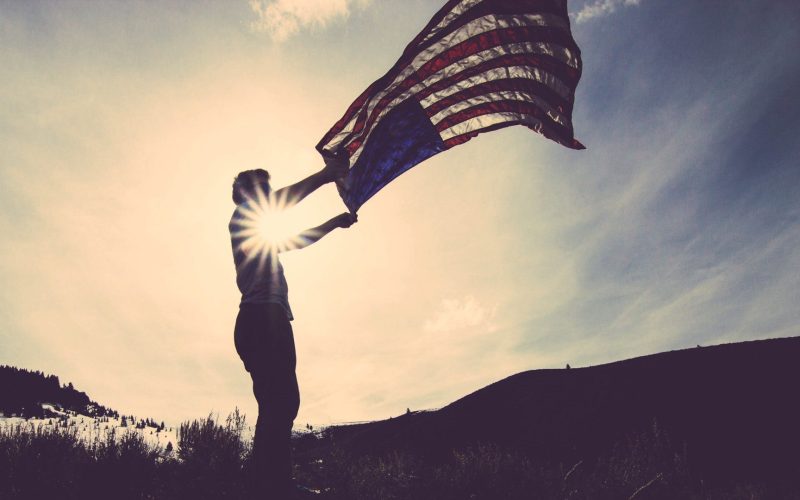 Man Flying American Flag
